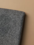 Side-angle view of dark gray tufting backing cloth highlighting its strong woven structure for added stability in rug tufting setups.