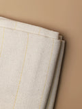Side-angle view of white primary tufting cloth highlighting its durable grid structure and sturdy backing for smooth tufting.