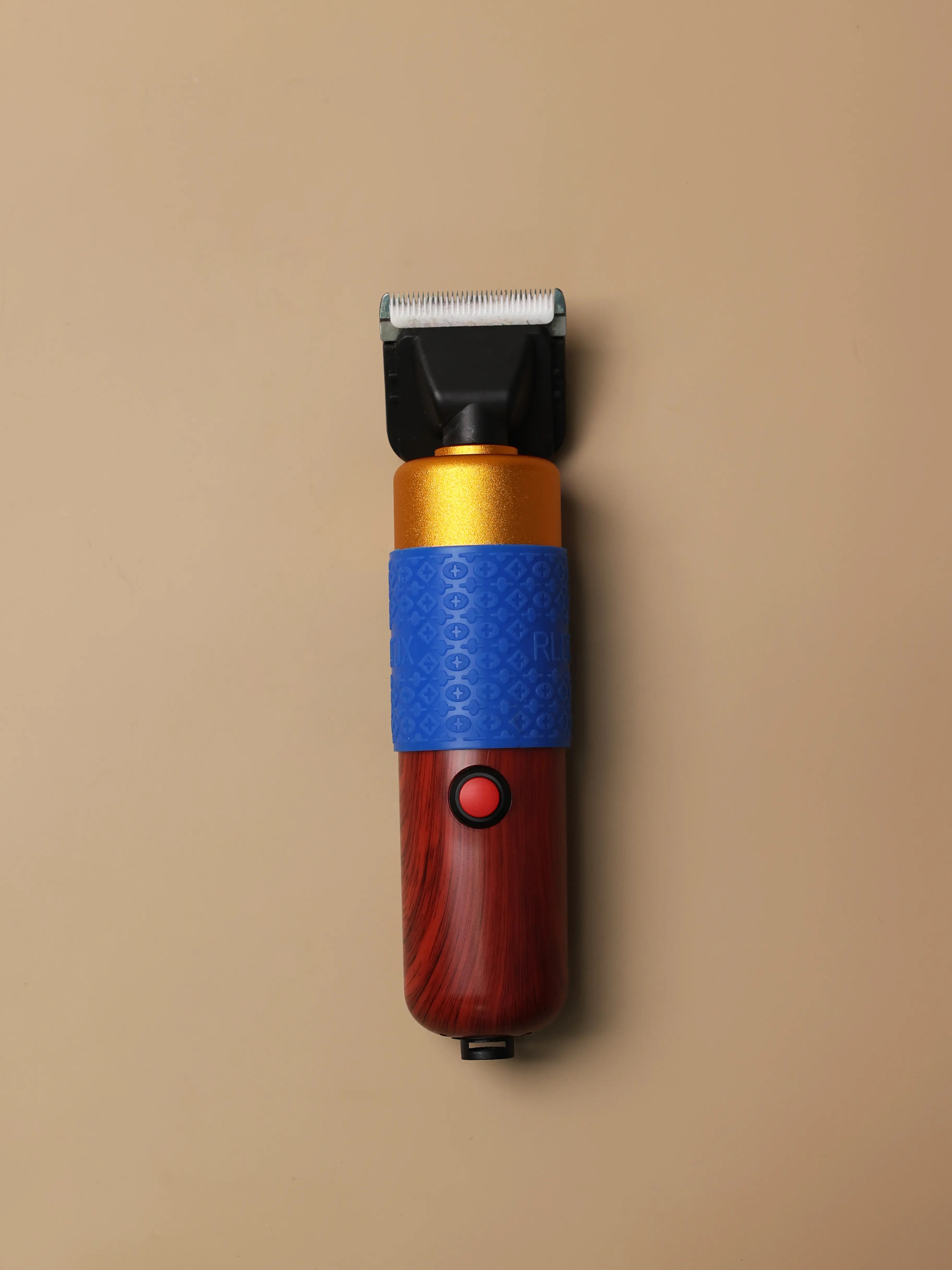 Front view of an electric rug trimmer showing its blade guard and flat base, used for shaving and smoothing tufted rugs.