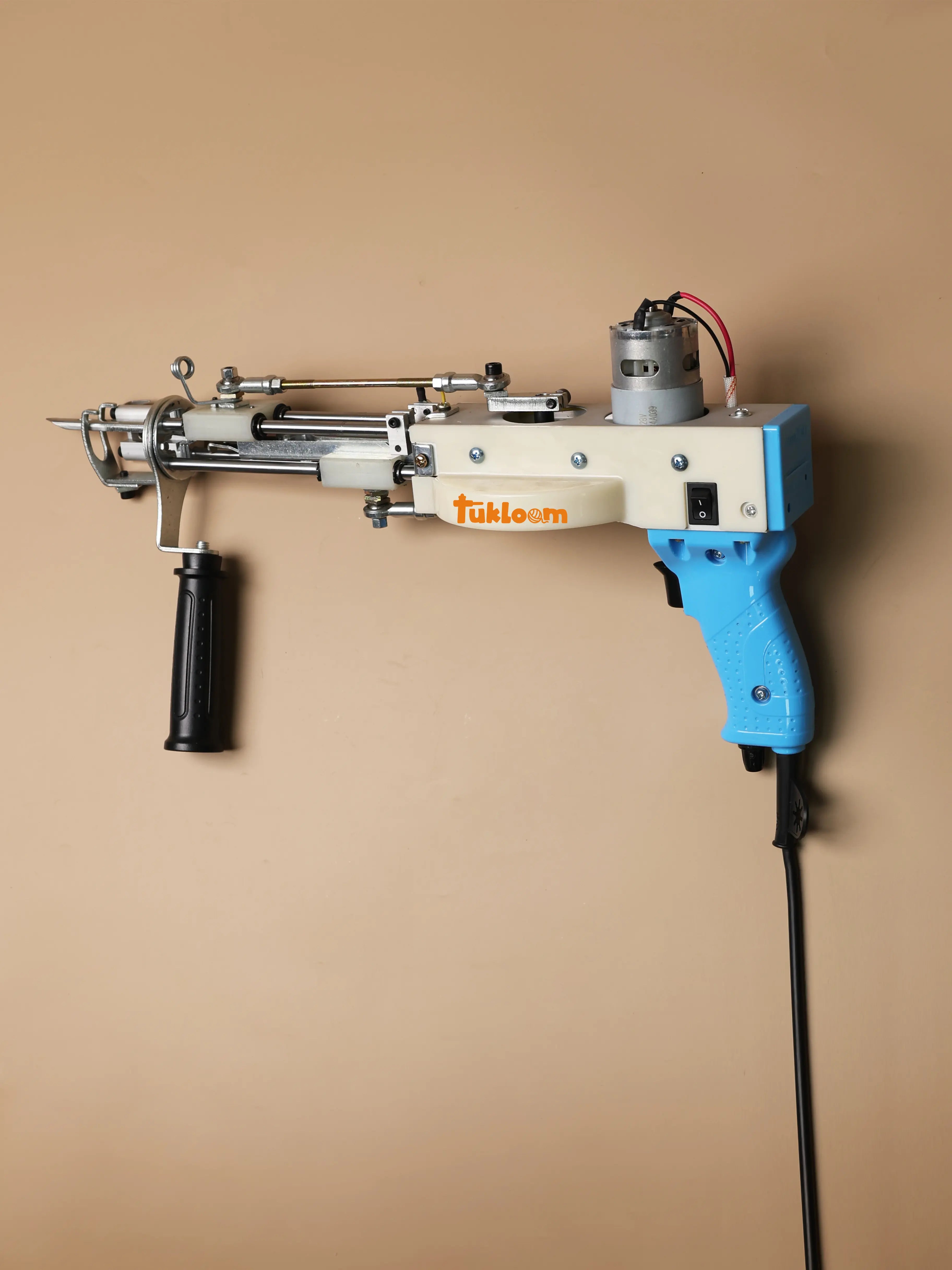 Close-up of long pile tufting gun showing adjustable speed control and dual-mode design for creating 3D shaggy rugs