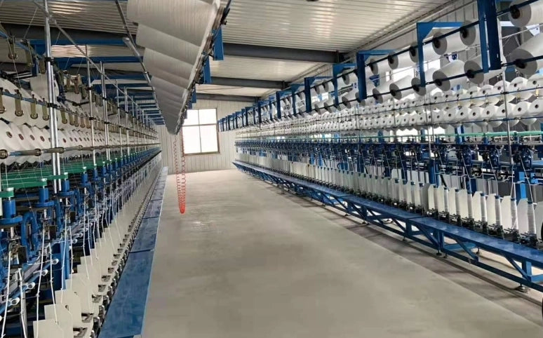 Yarn processing machines operating in Tukloom’s facility, ensuring consistent color and durable materials for tufting.