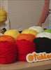 Mobile tufting video banner featuring hands using a tufting gun to create a rug design, showing beginner-friendly tufting steps by Tukloom.
